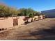Side yard with a gated entrance and landscaping at 25645 W Blue Sky Dr, Wittmann, AZ 85361