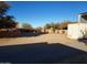 Front yard view of the property and storage containers at 25645 W Blue Sky Dr, Wittmann, AZ 85361