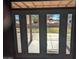 View of backyard patio and surrounding landscape through glass doors at 25645 W Blue Sky Dr, Wittmann, AZ 85361