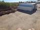 Aerial view of the property, showing a large container and yard at 25645 W Blue Sky Dr, Wittmann, AZ 85361