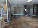 Spacious living room featuring a large window and stained concrete floors at 25645 W Blue Sky Dr, Wittmann, AZ 85361