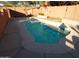 Kidney-shaped swimming pool in the backyard at 25645 W Blue Sky Dr, Wittmann, AZ 85361