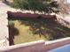 Landscaped backyard with low maintenance lawn and wall at 25645 W Blue Sky Dr, Wittmann, AZ 85361