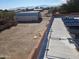 Aerial view of property, showing backyard, and storage containers at 25645 W Blue Sky Dr, Wittmann, AZ 85361