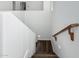 Modern staircase with wooden handrail and dark flooring at 3529 N Hooper St, Buckeye, AZ 85396