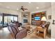 Living room with a stone fireplace, built-in shelving, and leather furniture at 31416 N 166Th Pl, Scottsdale, AZ 85262