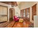 Bright sitting area with hardwood floors, built-in cabinetry, and French doors at 10040 E Happy Valley Rd # 676, Scottsdale, AZ 85255