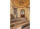 Elegant entryway with a coffered ceiling, arched doorway, and tiled steps at 10040 E Happy Valley Rd # 676, Scottsdale, AZ 85255