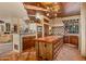 Rustic kitchen with wooden cabinetry, large island, and professional-grade appliances at 10040 E Happy Valley Rd # 676, Scottsdale, AZ 85255