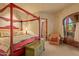 Charming bedroom with a red four-poster bed and access to a private patio at 10040 E Happy Valley Rd # 676, Scottsdale, AZ 85255