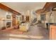 Elegant living room with a fireplace, spiral staircase, and high ceilings at 10040 E Happy Valley Rd # 676, Scottsdale, AZ 85255
