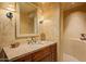 Elegant bathroom with a rustic vanity and a large mirror at 10040 E Happy Valley Rd # 676, Scottsdale, AZ 85255