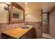 Rustic bathroom with terracotta tile and a wooden vanity at 10040 E Happy Valley Rd # 676, Scottsdale, AZ 85255