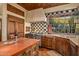 Spacious kitchen with wooden cabinetry, a large island, and checkered backsplash at 10040 E Happy Valley Rd # 676, Scottsdale, AZ 85255