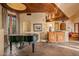 Living area featuring a grand piano and custom wood cabinetry at 10040 E Happy Valley Rd # 676, Scottsdale, AZ 85255