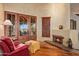 Relaxing sitting area with a fireplace, comfortable armchair, and French doors at 10040 E Happy Valley Rd # 676, Scottsdale, AZ 85255