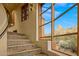 Stone staircase with a large window showcasing scenic mountain views at 10040 E Happy Valley Rd # 676, Scottsdale, AZ 85255