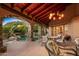 Spacious covered patio with fireplace, dining area, and mountain views at 10040 E Happy Valley Rd # 676, Scottsdale, AZ 85255