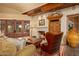Cozy living room features a fireplace, comfortable seating, and French doors leading to the patio at 10040 E Happy Valley Rd # 676, Scottsdale, AZ 85255