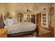 Large bedroom with king-size bed and access to a private patio and fireplace at 10040 E Happy Valley Rd # 676, Scottsdale, AZ 85255