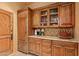 Kitchen features wooden cabinetry, granite countertops, and glass-front cabinets at 10040 E Happy Valley Rd # 676, Scottsdale, AZ 85255