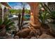 Landscaped pool area with waterfall and lush tropical plants at 10040 E Happy Valley Rd # 676, Scottsdale, AZ 85255
