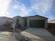 Single-story home with a two-car garage at 1069 W Elm Ave, Coolidge, AZ 85128