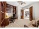 Home office with built-in shelves, desk, and access to another room at 3105 S Amble Pass, Gold Canyon, AZ 85118