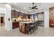 Spacious kitchen featuring granite countertops, dark wood cabinets, and stainless steel appliances at 3105 S Amble Pass, Gold Canyon, AZ 85118