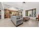 Bright living room with sectional sofa, stone accent wall, and access to backyard at 3105 S Amble Pass, Gold Canyon, AZ 85118