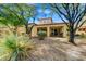 Landscaped backyard with mature trees and gravel at 3105 S Amble Pass, Gold Canyon, AZ 85118