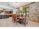 Rustic dining room with a large wooden table and stone accent wall at 3105 S Amble Pass, Gold Canyon, AZ 85118