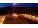 Night view of residents enjoying a fire pit on a patio at 3105 S Amble Pass, Gold Canyon, AZ 85118