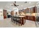 Island kitchen with dark wood cabinets, granite countertops, and stainless steel appliances at 3105 S Amble Pass, Gold Canyon, AZ 85118