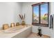 Relaxing bathroom with an oval bathtub and window with blinds at 3105 S Amble Pass, Gold Canyon, AZ 85118