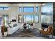 Bright living room with high ceilings, fireplace, and large windows at 34749 N 83Rd Way, Scottsdale, AZ 85266
