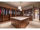 Spacious walk-in closet with custom built-ins and center island at 865 E Monte Vista Trl, Wickenburg, AZ 85390