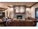 Elegant living room with a stone fireplace and comfortable leather sofas at 865 E Monte Vista Trl, Wickenburg, AZ 85390