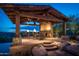 Elegant outdoor patio with fireplace and seating area, perfect for entertaining at 865 E Monte Vista Trl, Wickenburg, AZ 85390
