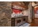 Gourmet kitchen with high-end appliances and rustic stone accents at 865 E Monte Vista Trl, Wickenburg, AZ 85390