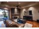 Cozy Gathering room featuring a stone fireplace, built-in entertainment center, and hardwood floors at 865 E Monte Vista Trl, Wickenburg, AZ 85390