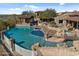 Resort-style pool and spa with a stone patio and pergola at 865 E Monte Vista Trl, Wickenburg, AZ 85390