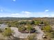 Aerial view of house with circular driveway and landscaped yard at 865 E Monte Vista Trl, Wickenburg, AZ 85390