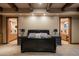 Spacious bedroom with large bed and access to dual bathrooms at 865 E Monte Vista Trl, Wickenburg, AZ 85390