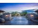 Grand entry with a long driveway and illuminated pillars at 865 E Monte Vista Trl, Wickenburg, AZ 85390