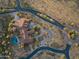 Aerial view of a house with a circular driveway and landscaped yard at 865 E Monte Vista Trl, Wickenburg, AZ 85390