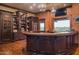 Custom wet bar with wine storage, cabinetry and a granite countertop at 865 E Monte Vista Trl, Wickenburg, AZ 85390