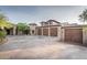 Large four car garage with wood doors and ample parking at 865 E Monte Vista Trl, Wickenburg, AZ 85390