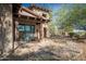 Home exterior showcasing stonework and a wooden covered patio at 865 E Monte Vista Trl, Wickenburg, AZ 85390