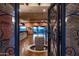 Ornate entry gate opens to a spacious foyer with water feature at 865 E Monte Vista Trl, Wickenburg, AZ 85390